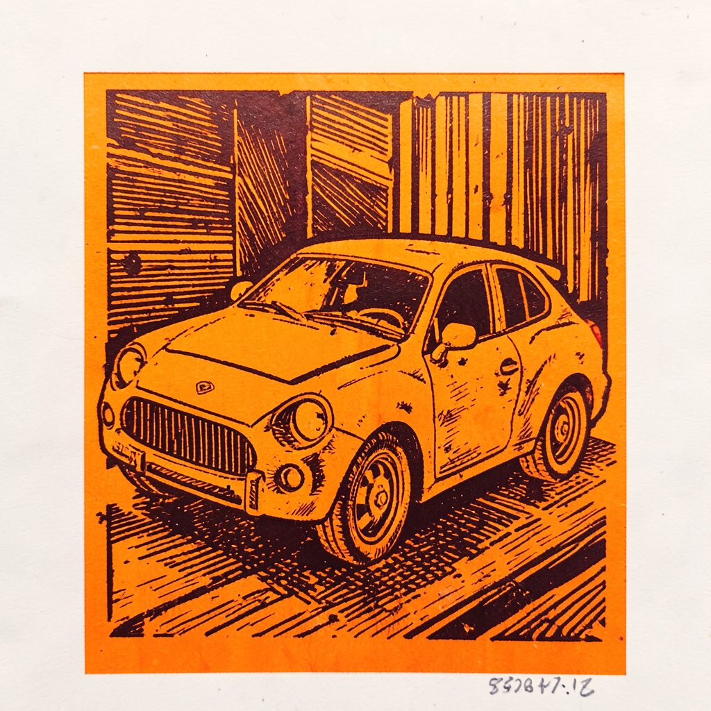 Carved linocut relief print of small project blocks arranged in a grid, warm orange highlights